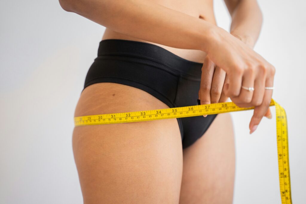 Woman measuring her waist